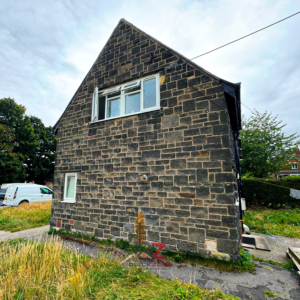 stone house home extension under construction with scaffolding