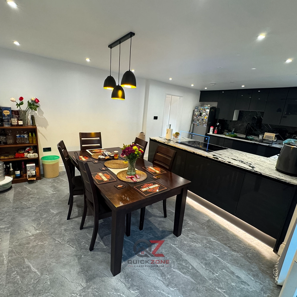 luxury kitchen renovation with black cabinets and marble worktop
