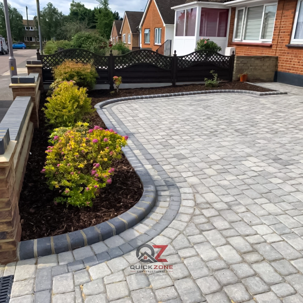 large curved driveway with block paving and garden landscaping