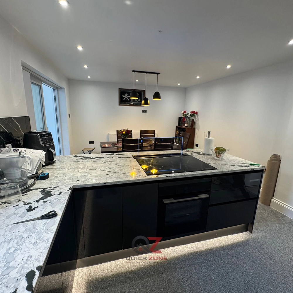 contemporary kitchen with wooden dining table and black units