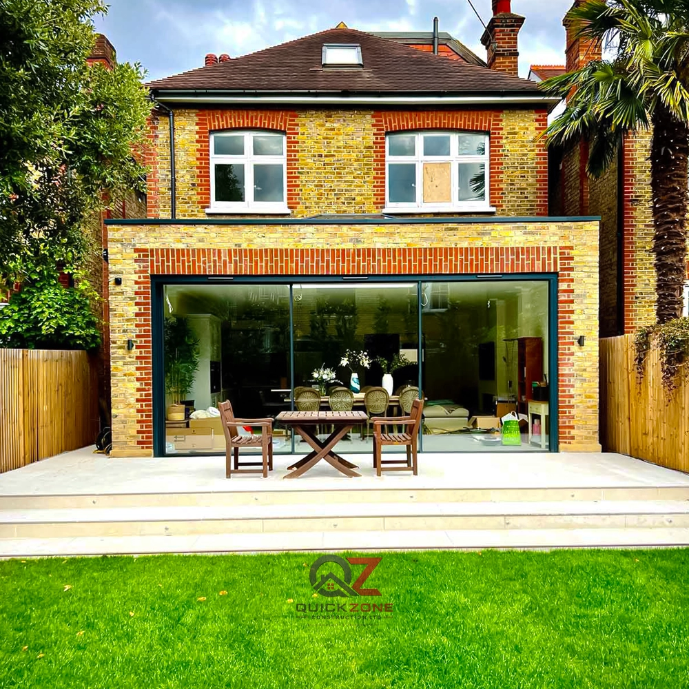 big modern house with glass extension and paved front driveway