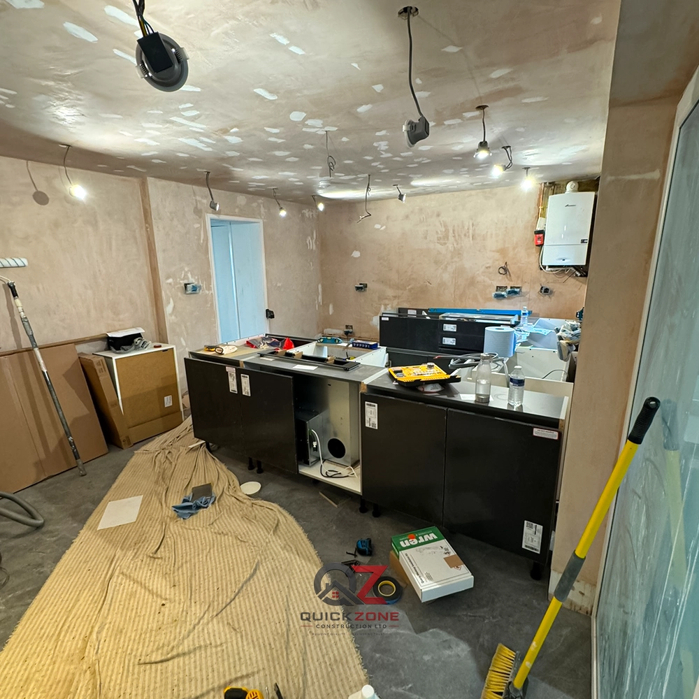 kitchen renovation in progress with tools and dust sheets